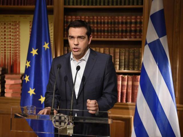 epa04827011 A handout picture released by the Greek Prime Minister's press office on 01 July 2015 of Greek Prime Minister Alexis Tsipras addressing the nation about the referendum on 05 July 2015, during a speech broadcasted from his office in Athens, Greece, 01 July 2015. Tsipras remained steadfast in his controversial plan to hold a referendum on the bailout demands of creditors, as eurozone finance ministers discussed a request from Athens for new financial aid. During the televized address to the nation Tsipras said that anyone equating a no-vote with a return to the drachma is 'telling lies,' and repeated his call for people to vote against the measures.  EPA/ANDREA BONETTI/PRIME MINISTER OF GREECE PRESS OFFICE/HANDOUT  HANDOUT EDITORIAL USE ONLY/NO SALES